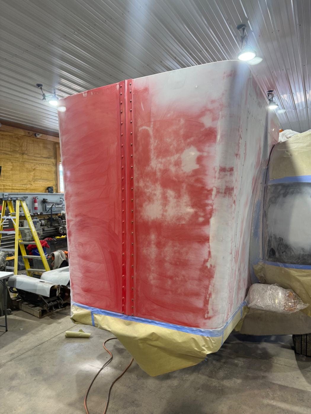 A red panel sanded down for bodywork.